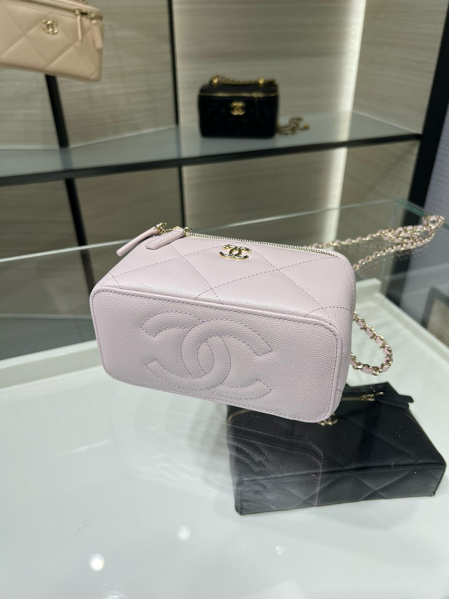 Chanel light pink quilted mini bag with gold CC clasp, top zip, and handle