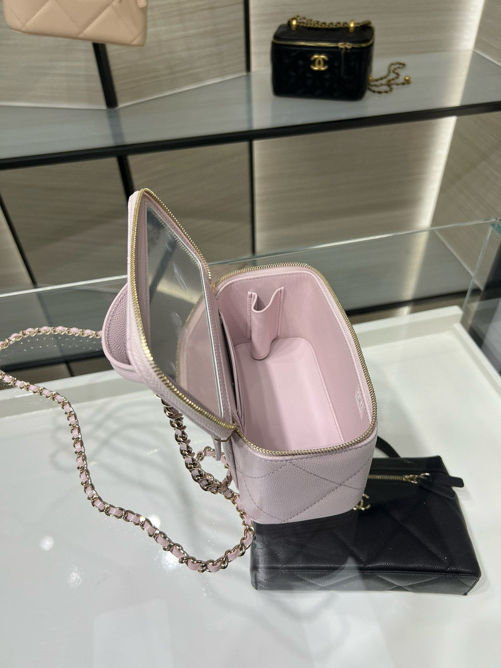 Chanel light pink mini bag open view showing interior lining and chain strap