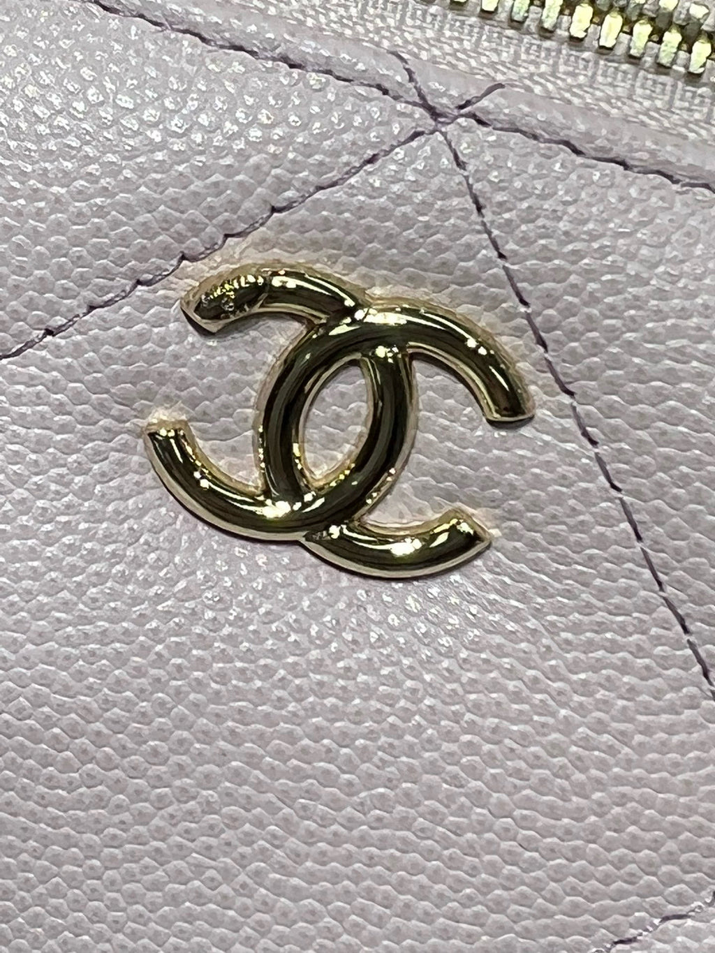 Chanel CC logo detail in gold on light pink textured leather