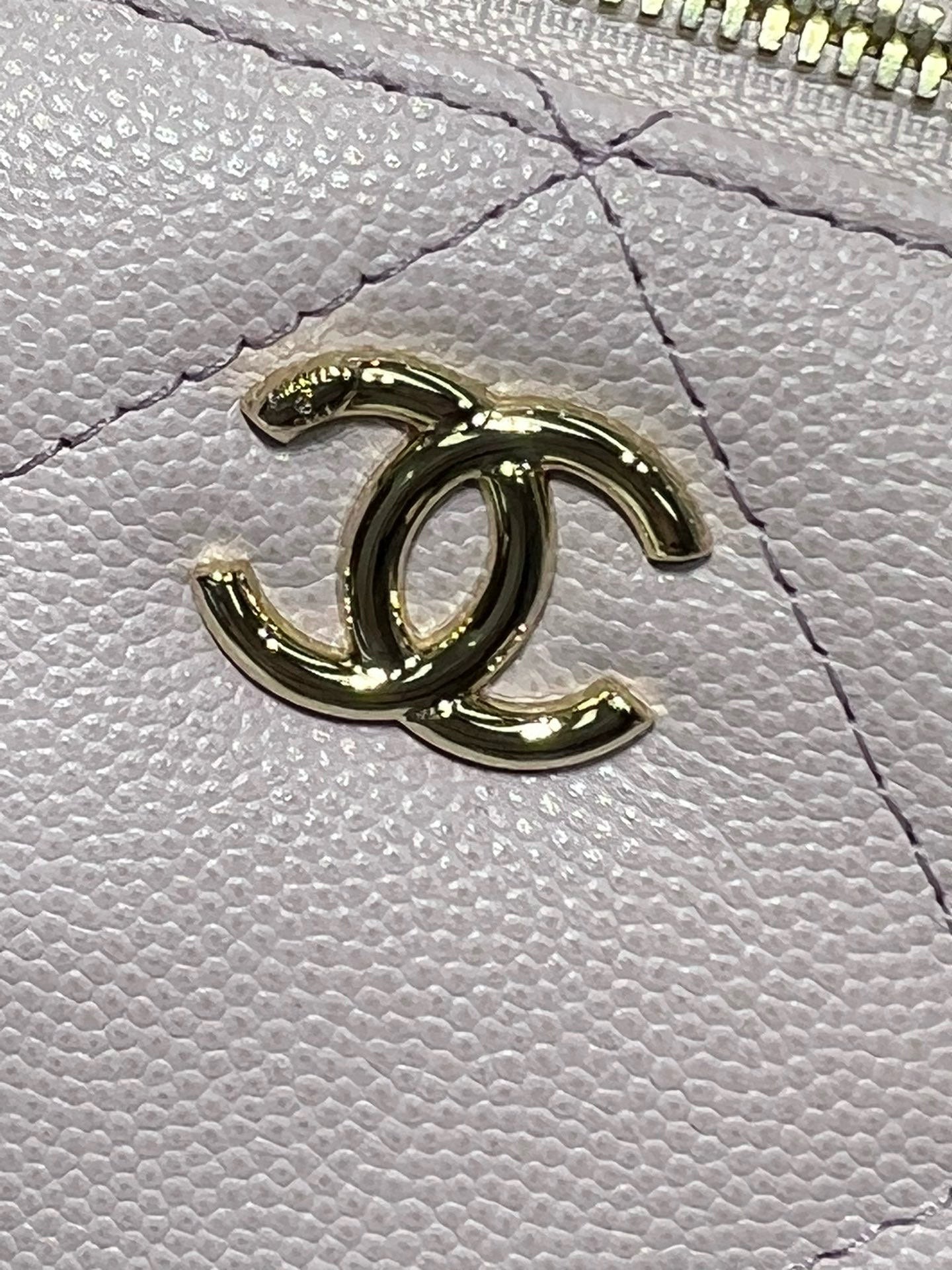 Chanel CC logo detail in gold on light pink textured leather