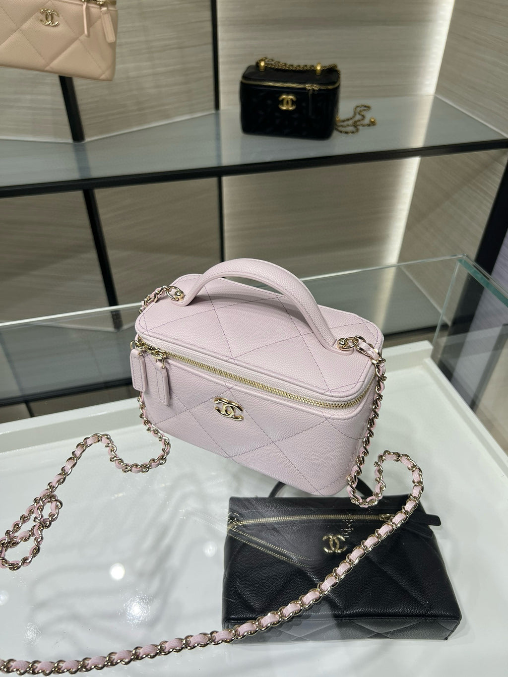 Chanel light pink mini bag with chain strap and top zip, front view