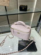 Chanel light pink mini bag with chain strap and top zip, front view