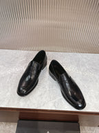 Black leather slip-on loafers, side view, smooth upper and low heel
