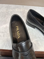 Black leather loafer with Prada logo on insole, close-up of interior