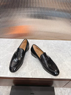 Black leather unisex loafers, angled view with square buckle on vamp.