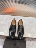 Black leather unisex loafers with square buckle detail, low heel.