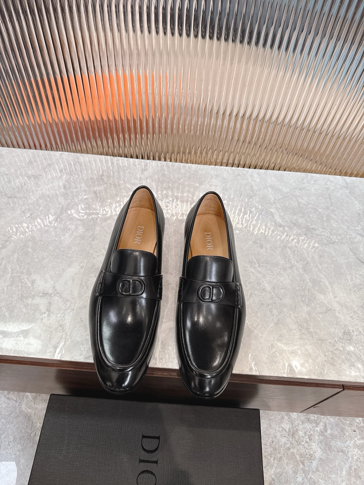 Black leather unisex loafers with square buckle detail, low heel.