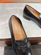 Black leather unisex loafer with tan insole and stitched edge detail.