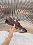 Burgundy leather loafer on display, DD strap detail and low sole