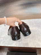 Burgundy leather loafer backs, low heel and cushioned lining visible