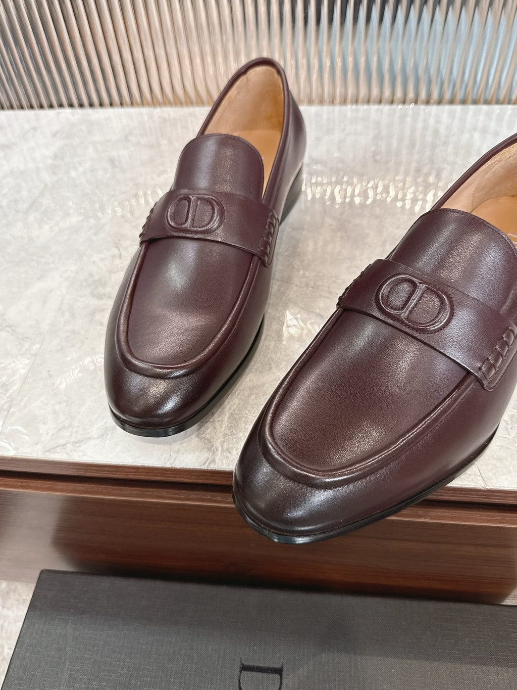 Burgundy leather loafers with DD strap detail, front view on display