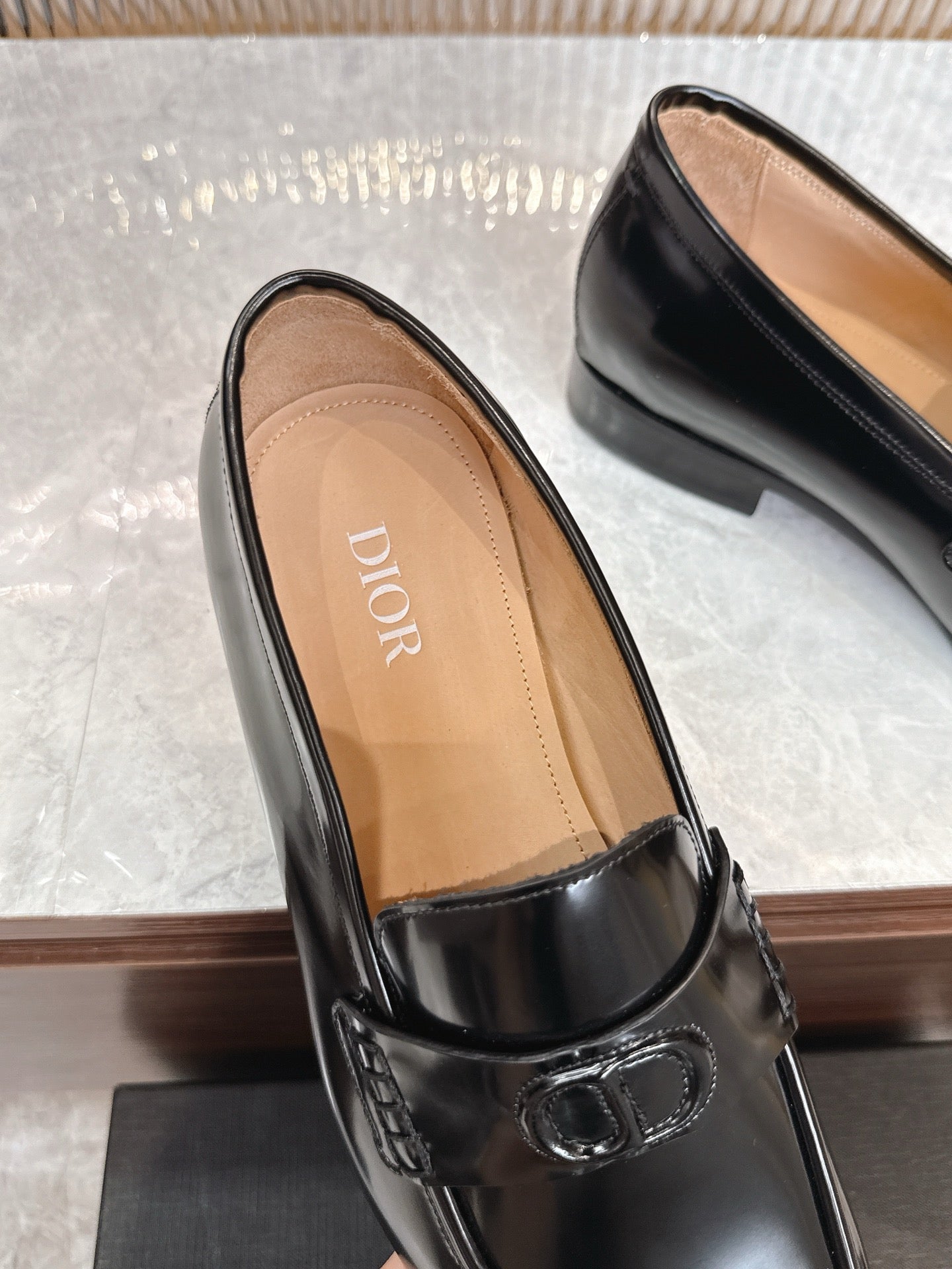 Dior unisex black leather loafer close-up, tan insole and buckle detail