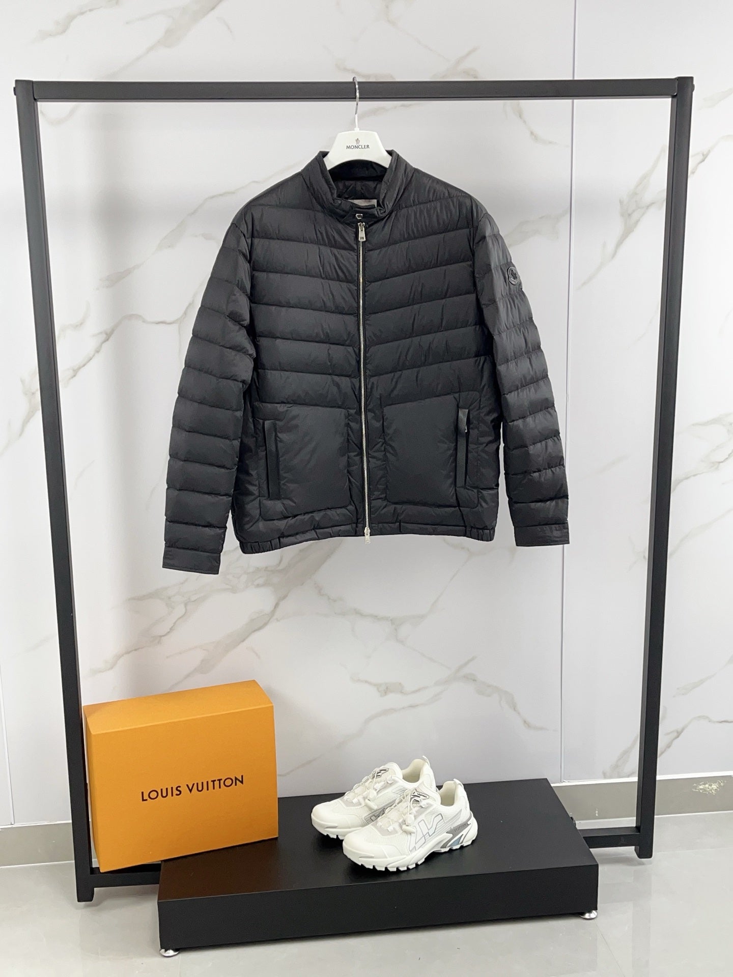 Moncler long padded jacket, dark gray with two front zip pockets and stand collar.