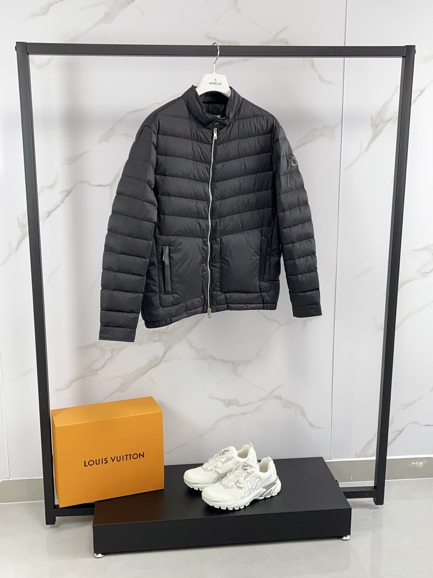 Moncler long padded jacket, dark gray quilted puffer with side zip pockets.