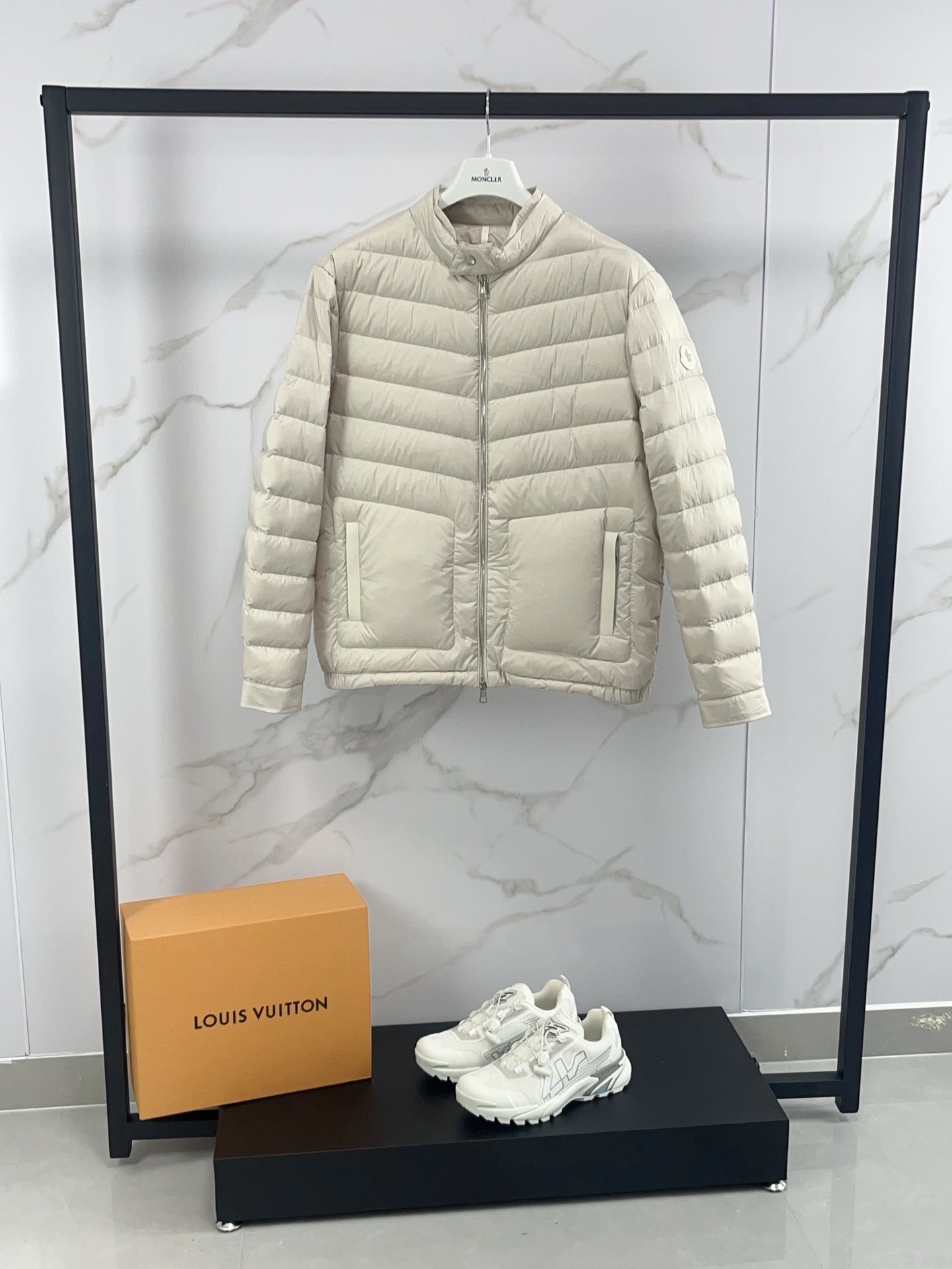 Moncler light beige quilted puffer jacket front view with stand collar