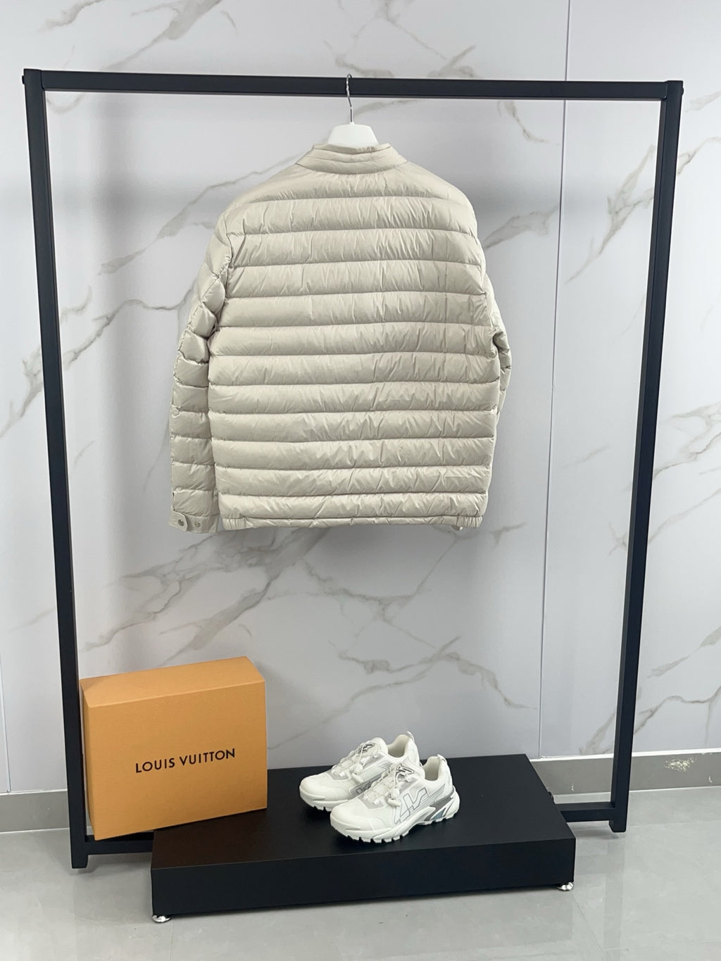 Moncler light beige quilted puffer jacket back view with horizontal stitching