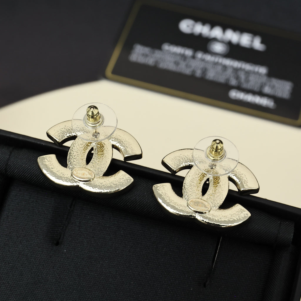 Chanel CC logo cufflink-style earrings in gold-tone finish on black fabric