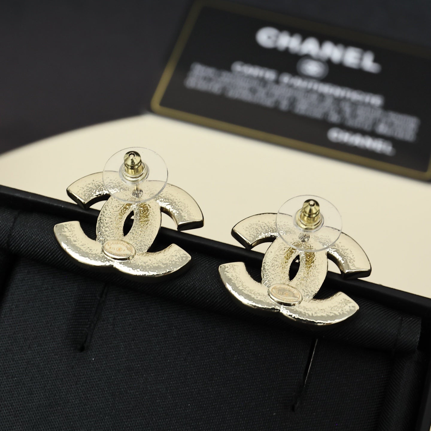 Chanel CC logo cufflink-style earrings in gold-tone finish on black fabric