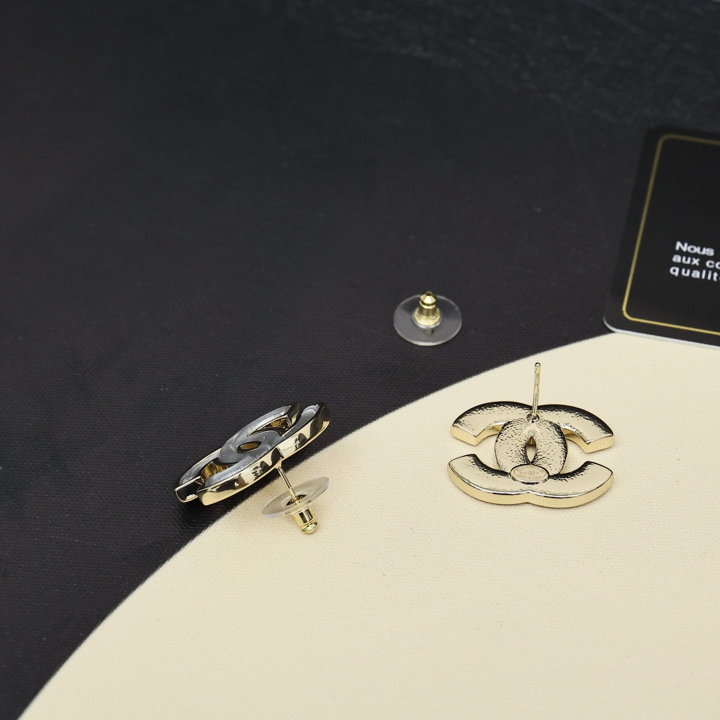 Chanel CC logo stud earrings, gold-tone backs visible with gift box packaging
