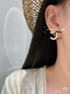 Pearl and gold-tone chain hoop earring with small pearl accents near the top