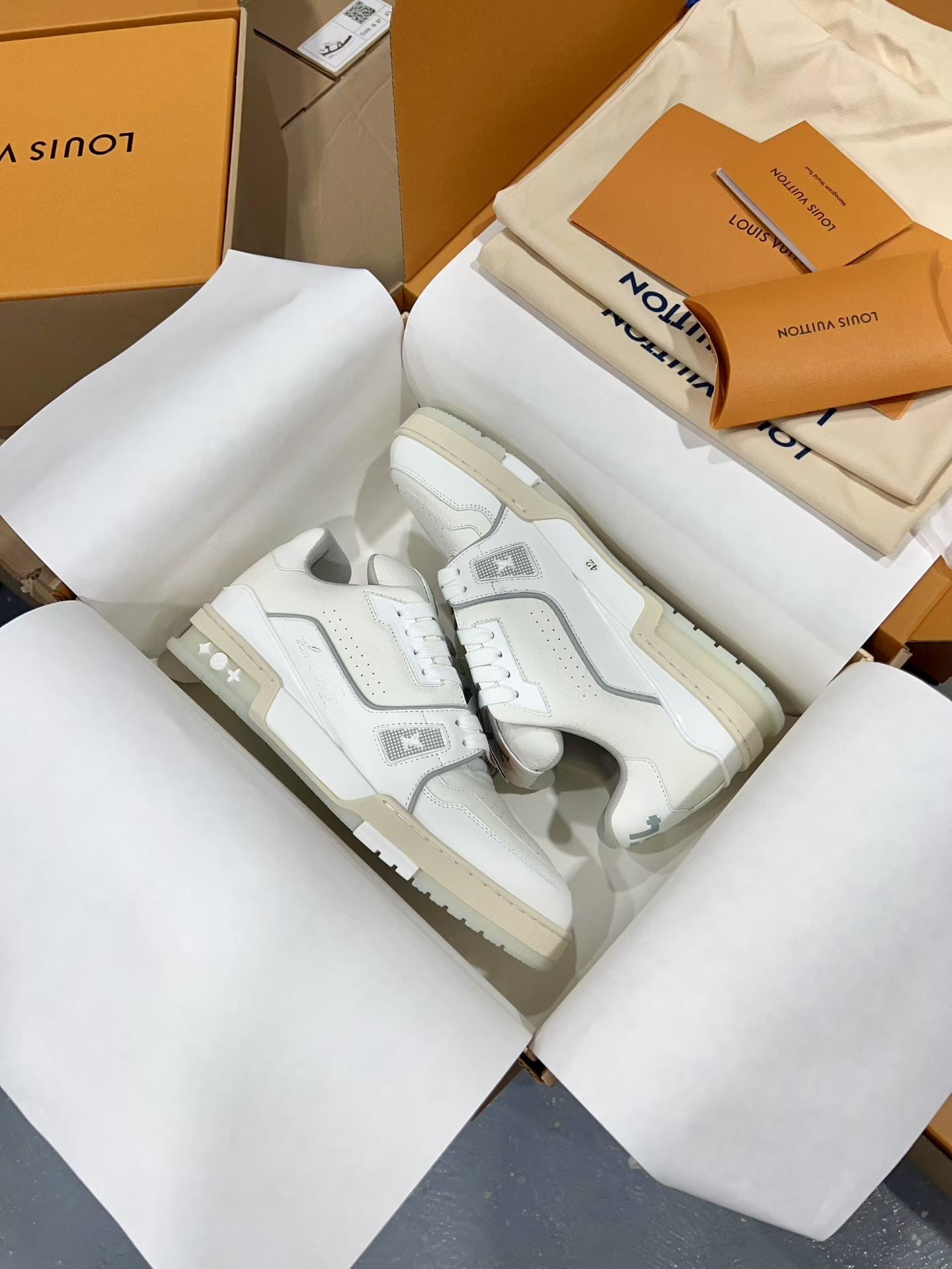 White Louis Vuitton trainer sneakers with chunky sole and lace-up front, in open box