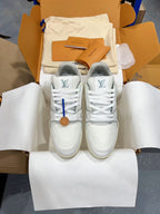 Pair of white Louis Vuitton trainer sneakers with lace-up front and LV tongue logos