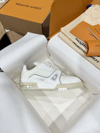White Louis Vuitton trainer sneaker with lace-up front and side LV emblem on tissue paper