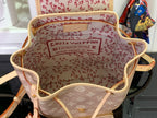 Louis Vuitton monogram backpack open interior with red patterned lining and brand patch