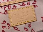Louis Vuitton interior leather tag with logo, "made in France" text, and yellow edge stitching