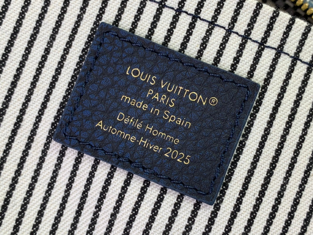 Navy fabric tag: Louis Vuitton Paris, made in Spain, Defile Homme Hiver 2025.