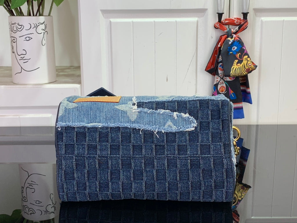 Blue denim patchwork handbag back panel with flap and gold-tone hardware.