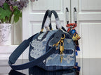 Louis Vuitton denim blue crossbody tote with patterned panels, top handles and strap