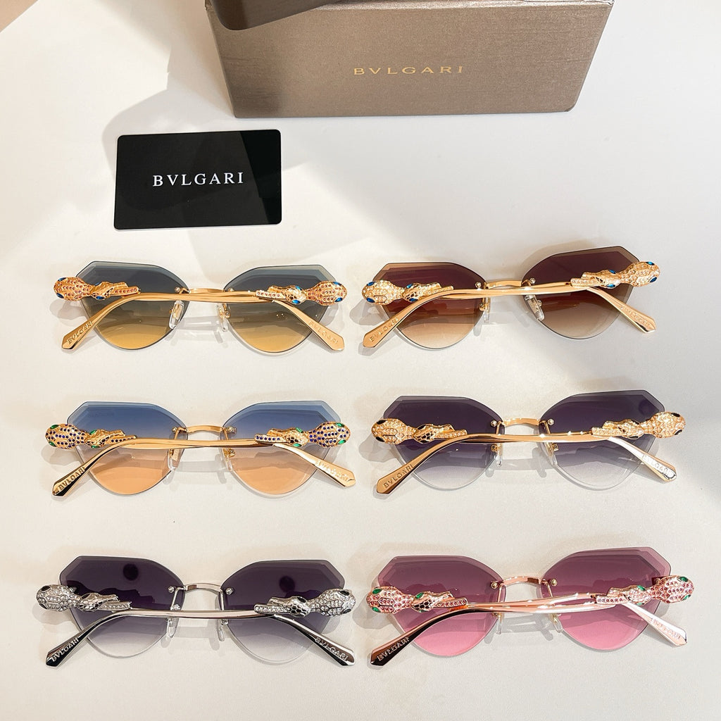 Set of four gold-tone sunglasses with tinted lenses and rhinestone-accented temples