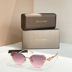 Gold-tone cat-eye sunglasses with pink gradient lenses and decorative hinge detail