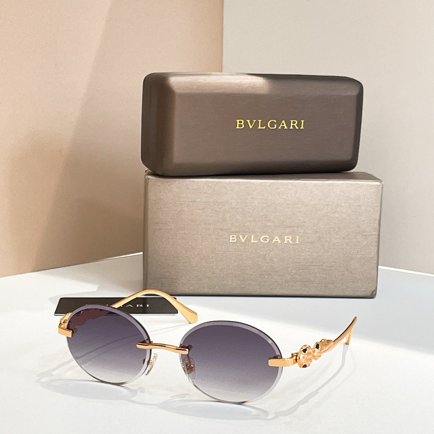 Bvlgari round sunglasses with gold-tone frame and dark blue tinted lenses