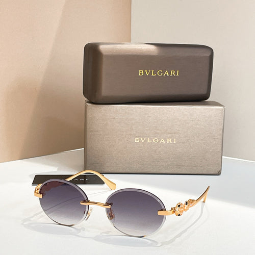 Bvlgari round sunglasses with gold-tone frame and dark blue tinted lenses