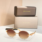 Bvlgari round sunglasses with gold-tone frame and amber-brown tinted lenses