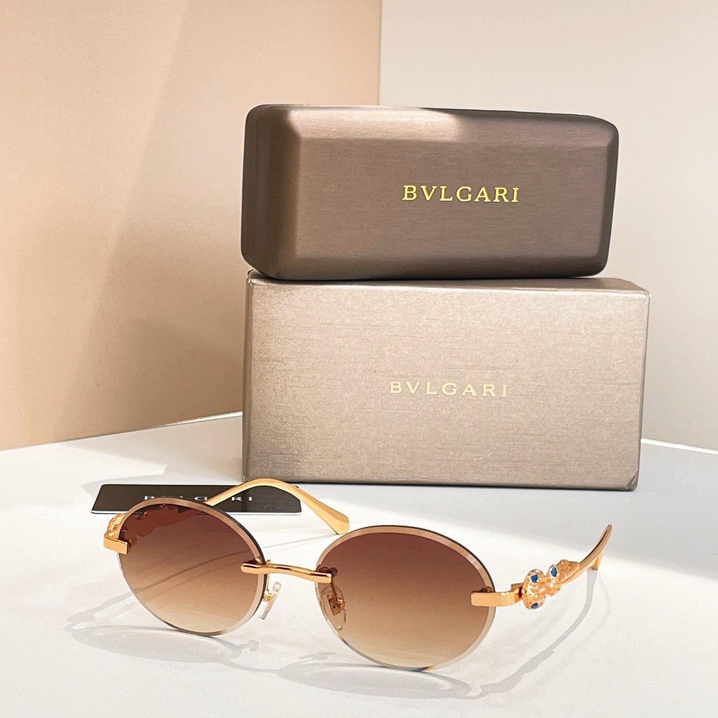 Bvlgari round sunglasses with gold-tone frame and amber-brown tinted lenses