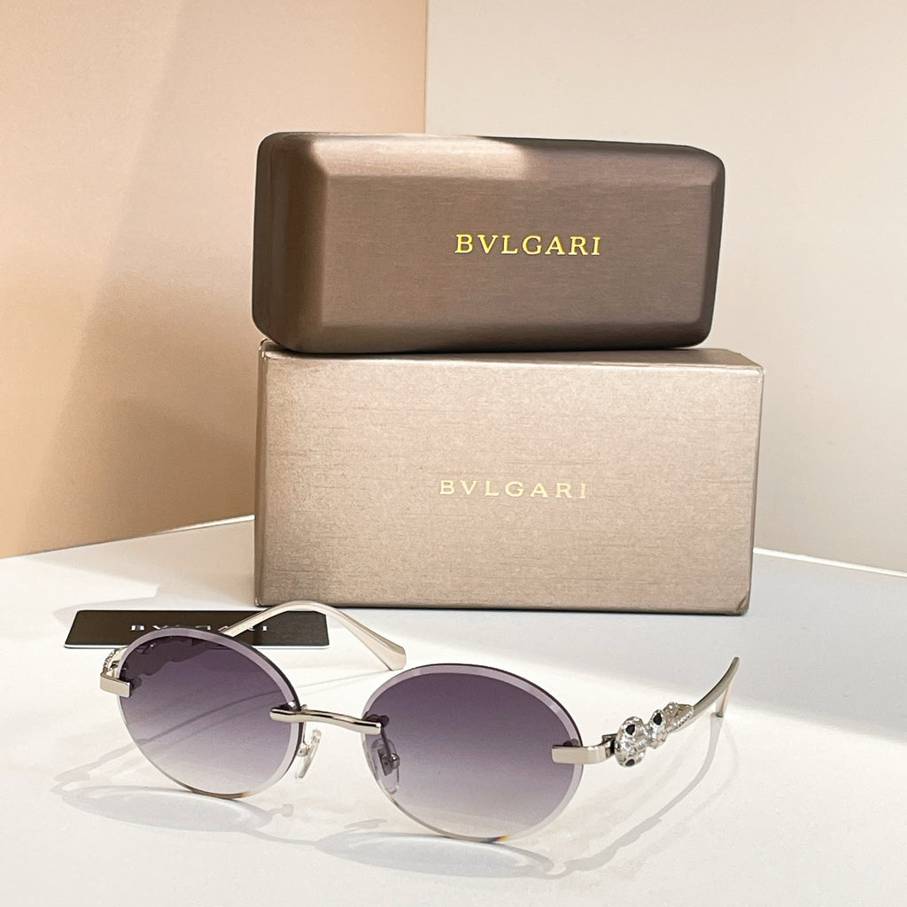 Bvlgari round sunglasses with gold-tone frame and dark purple tinted lenses
