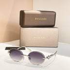 Bvlgari round sunglasses with gold-tone frame and dark purple tinted lenses