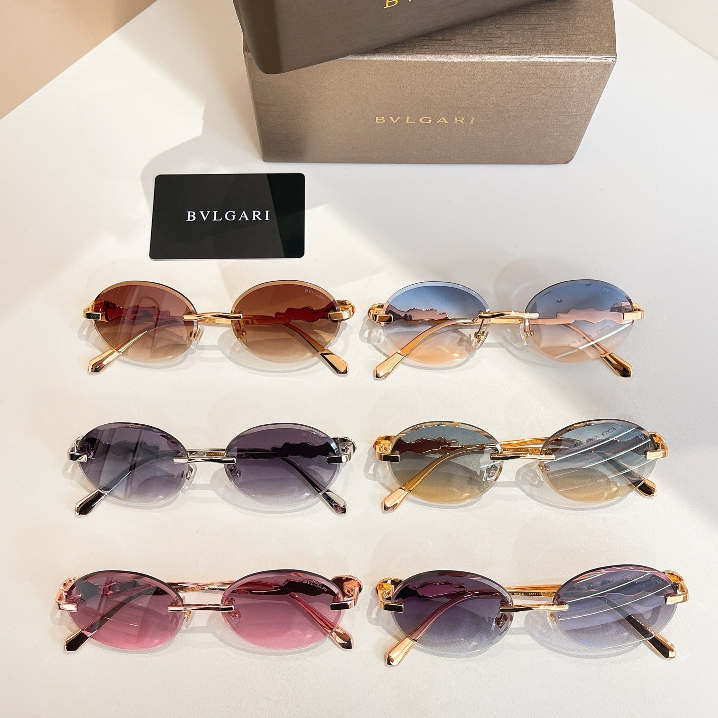 Bvlgari sunglasses display with multiple round pairs, tinted lenses, gold-tone frames