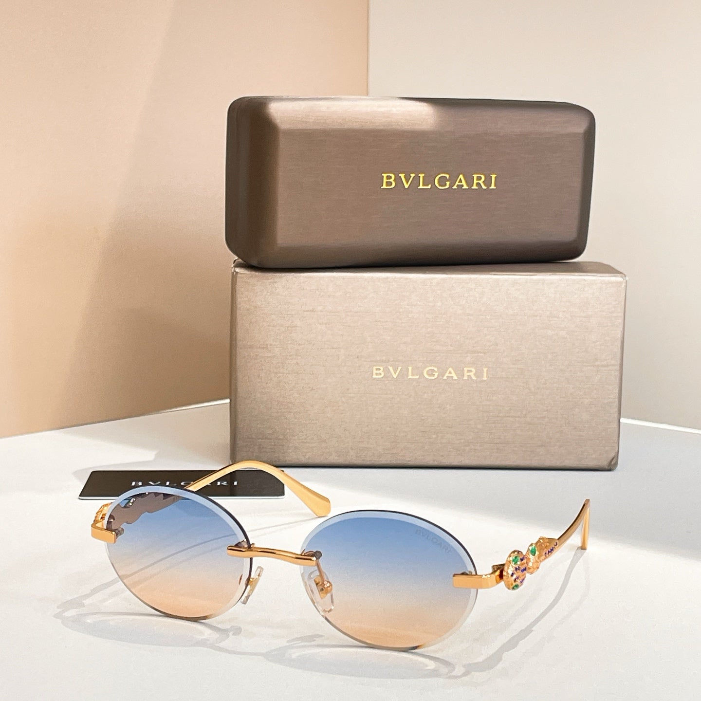 Bvlgari round sunglasses with gold-tone frame and blue tinted lenses