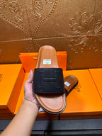 Front view black leather slide sandal with H strap, tan footbed