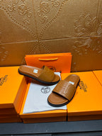 Tan leather Hermes slide sandals, one held back on box with square buckle strap