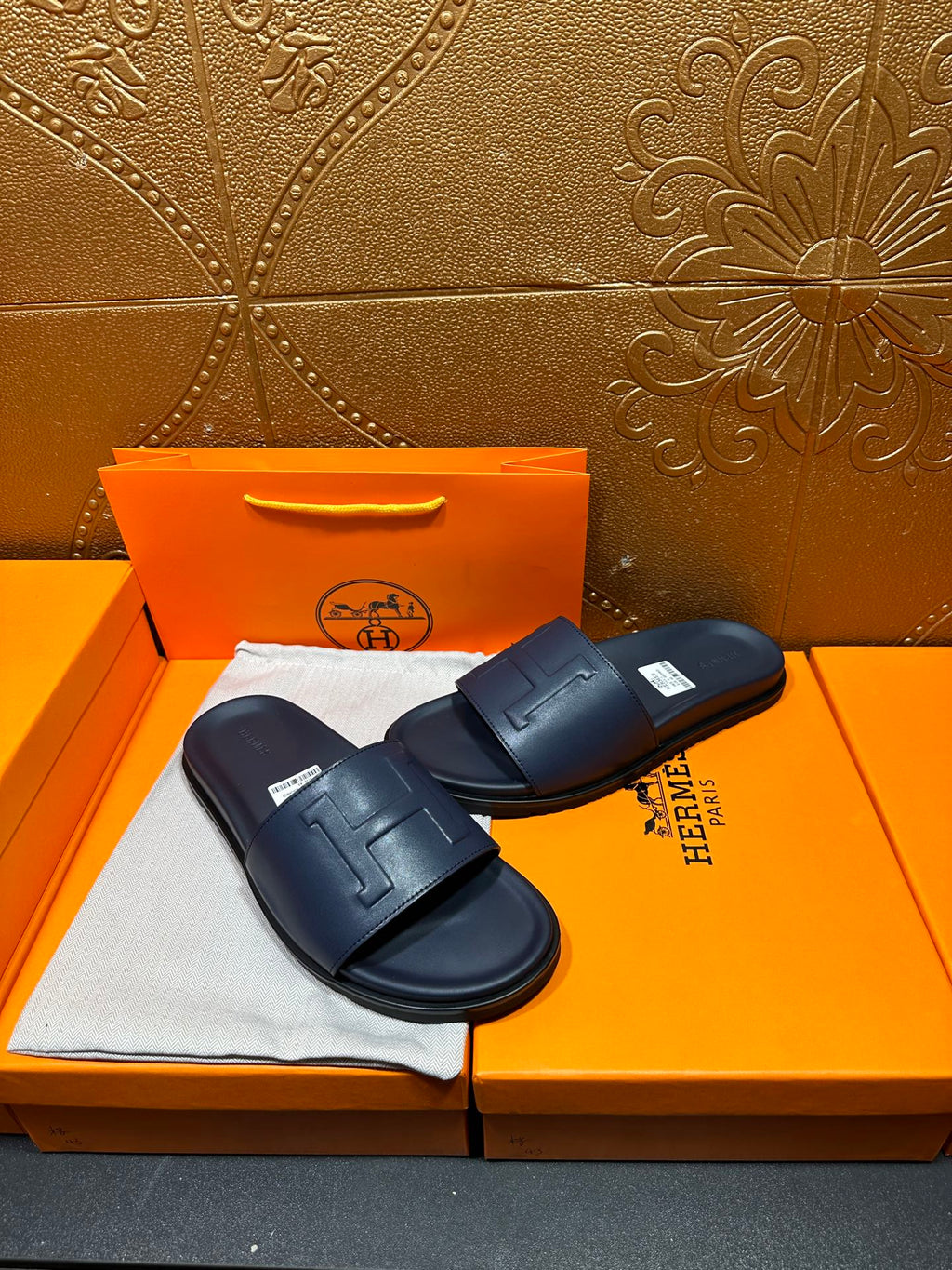 Hermes navy slide sandals with wide strap and cushioned rubber outsole