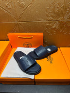 Hermes navy slide sandals with wide strap and cushioned rubber outsole