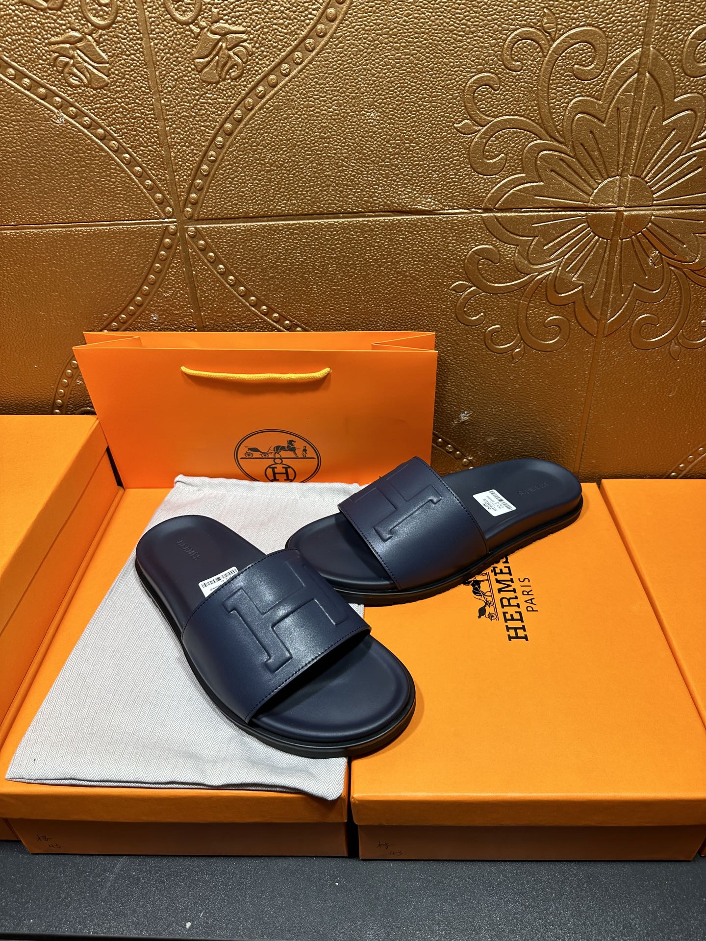 Hermes navy slide sandals with wide strap and cushioned rubber outsole