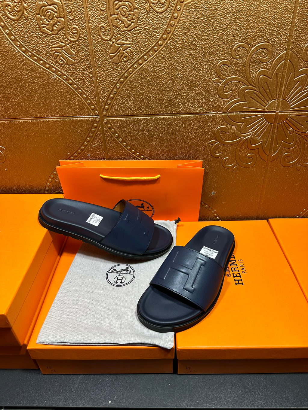 Hermes navy slide sandals with wide strap and molded, cushioned sole