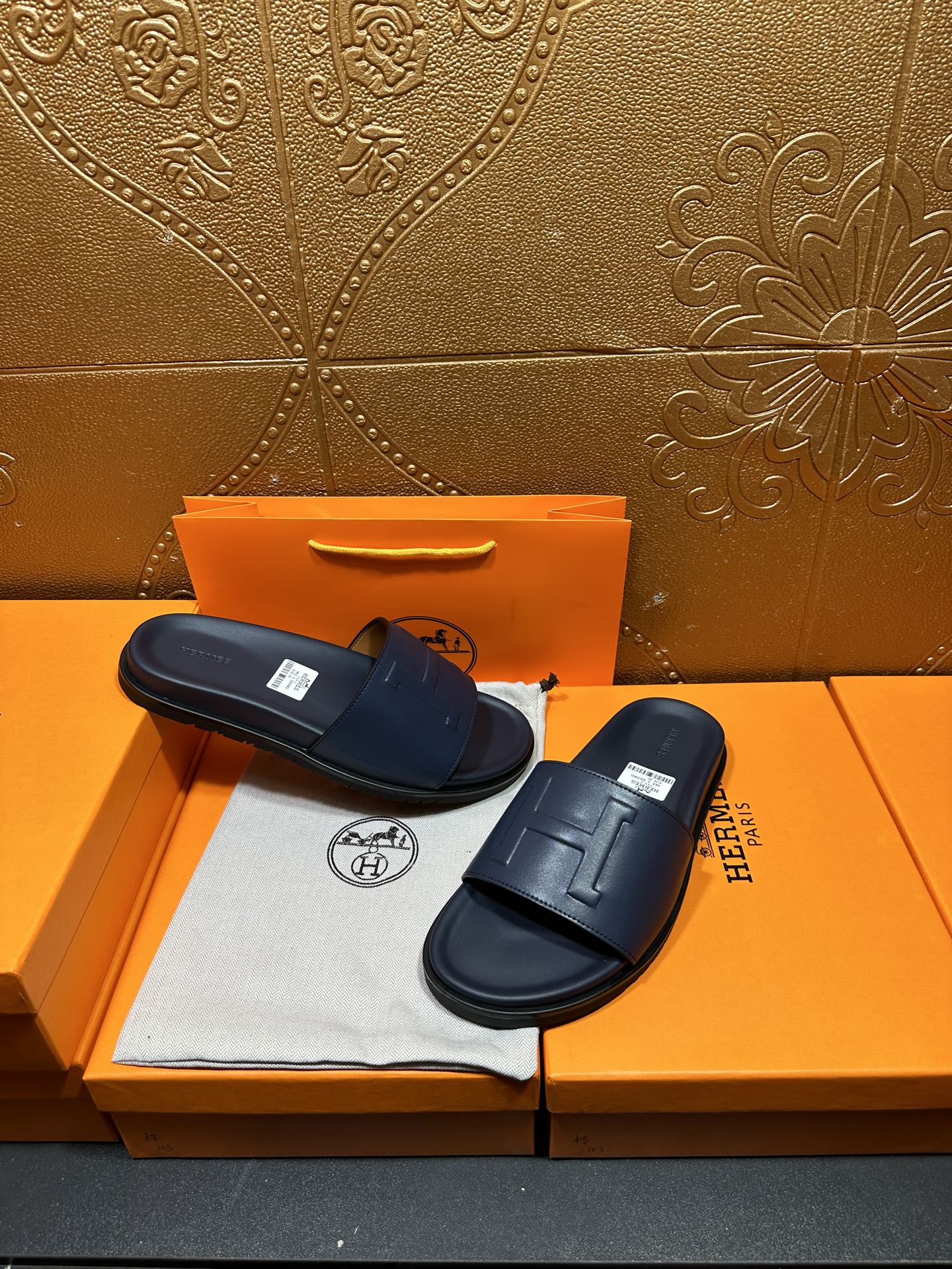 Hermes navy slide sandals with wide strap and molded, cushioned sole