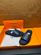 Hermes navy slide sandals, front H buckle detail and contoured footbed
